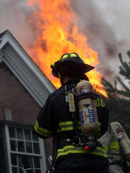 Millwood Firefighter Ryan Bruckenthal sizes up a working house fire on Chappaqua Road (07/31/09)